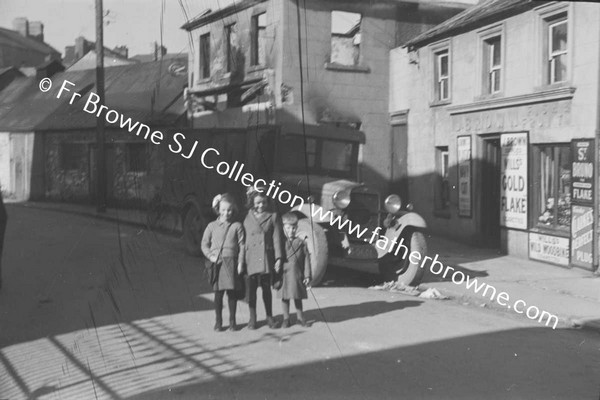 CHILDREN STANDING IN FRONT OF DELIVERY VAN